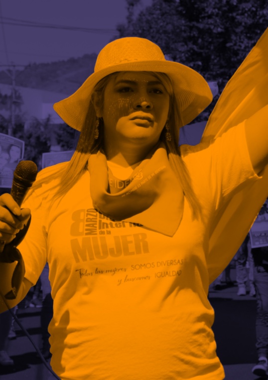 Bianka Rodriguez attends a protest and stands defiantly, with her left hand in a fist and right hand out of the image but seemingly holding a flag in the air. She is filtered in yellow and wears a brimmed hat, a neck scarf, and a short sleeve t-shirt. The background is filtered in indigo.